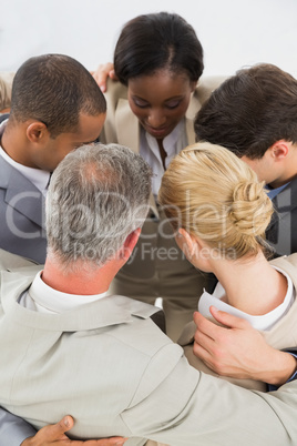 Close business team hugging in a circle