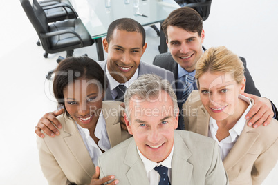 Close business team smiling up at camera