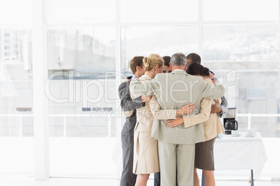 Business people hugging in a circle