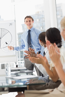 Businessman being applauded for his presentation