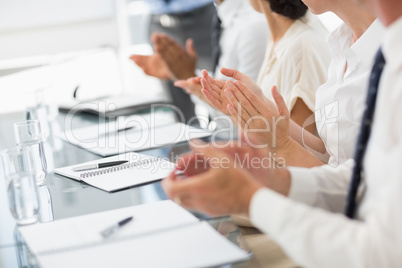 Business people clapping at a meeting