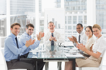 Business people clapping the camera at a meeting