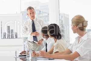 Business manager talking to staff during meeting