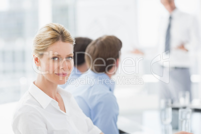 Businesswoman smiling at camera during a meeting