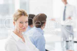 Businesswoman smiling at camera during a meeting