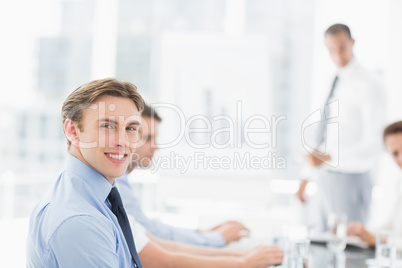 Smiling businessman looking at camera during a meeting
