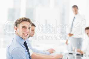 Smiling businessman looking at camera during a meeting