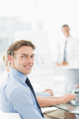 Happy businessman looking at camera during a meeting