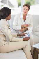 Businesswomen having a meeting to go over figures on the couch