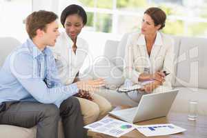 Business team meeting to go over numbers on the couch