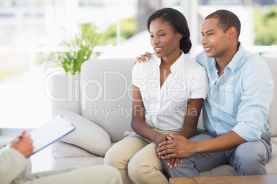 Young couple listening to salesman on the couch