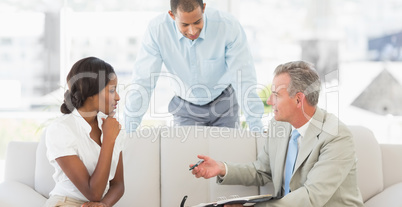 Salesman showing clients where to sign the deal