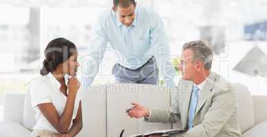 Salesman showing clients where to sign the deal