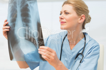 Surgeon studying an xray