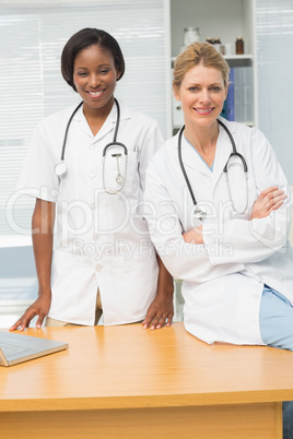 Doctor and nurse smiling at camera