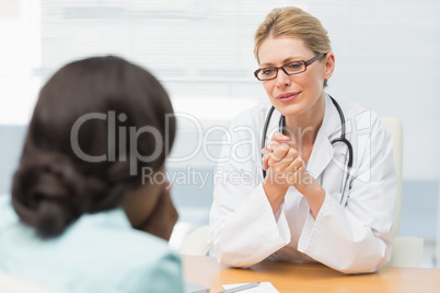 Concerned doctor listening to her patient