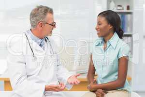 Doctor speaking with cheerful young patient