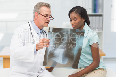 Doctor showing young patient her chest xray