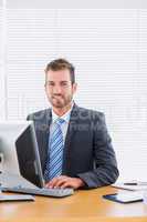 Businessman using computer at office desk
