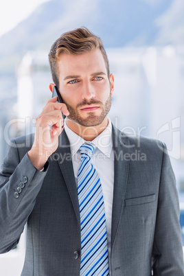 Handsome young businessman using mobile phone