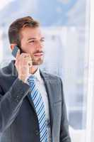 Handsome young businessman using mobile phone