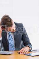 Thoughtful businessman sitting at office desk