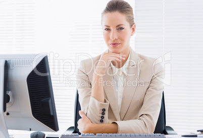 Serious businesswoman with computer at office desk Serious businesswoman with computer at office desk