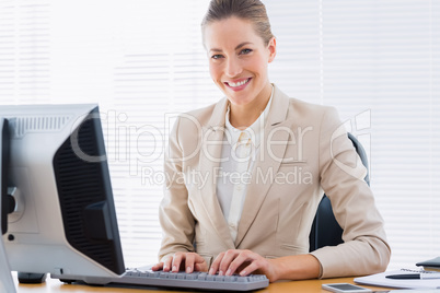 Businesswoman using computer at office desk