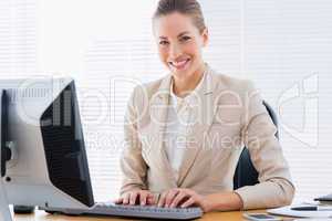 Businesswoman using computer at office desk