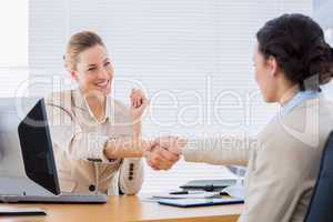 Women shaking hands in a business meeting