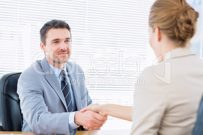 Executives shaking hands after a business meeting