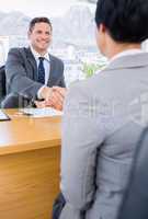 Executives shaking hands after a business meeting