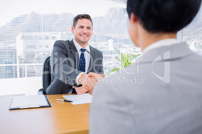 Executives shaking hands after a business meeting