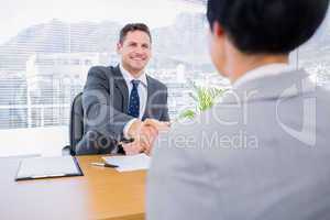 Executives shaking hands after a business meeting