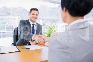 Executives shaking hands after a business meeting