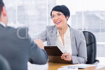 Executives shaking hands after a business meeting