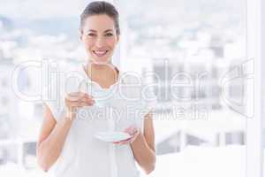 Smiling businesswoman with tea cup in office