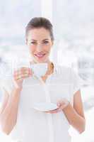 Smiling young businesswoman with tea cup