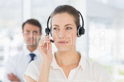 Close-up of a beautiful female executive with headset