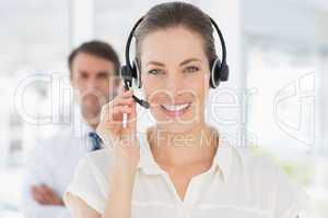 Close-up of a beautiful female executive with headset