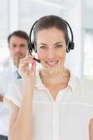 Beautiful female executive with headset