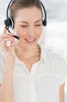 Beautiful female executive with headset