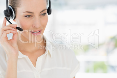 Close-up of a beautiful female executive with headset