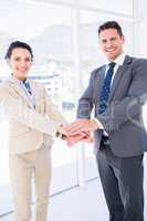 Cheerful business colleagues joining hands together