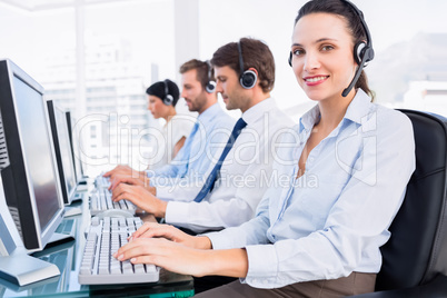 Business colleagues with headsets using computers