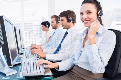 Business colleagues with headsets using computers