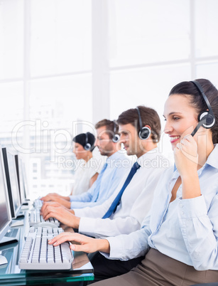 Business colleagues with headsets using computers