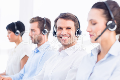 Business colleagues with headsets in a row