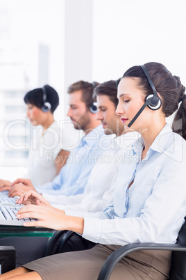 Business colleagues with headsets in a row