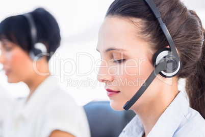 Close-up of a beautiful female executive with headset